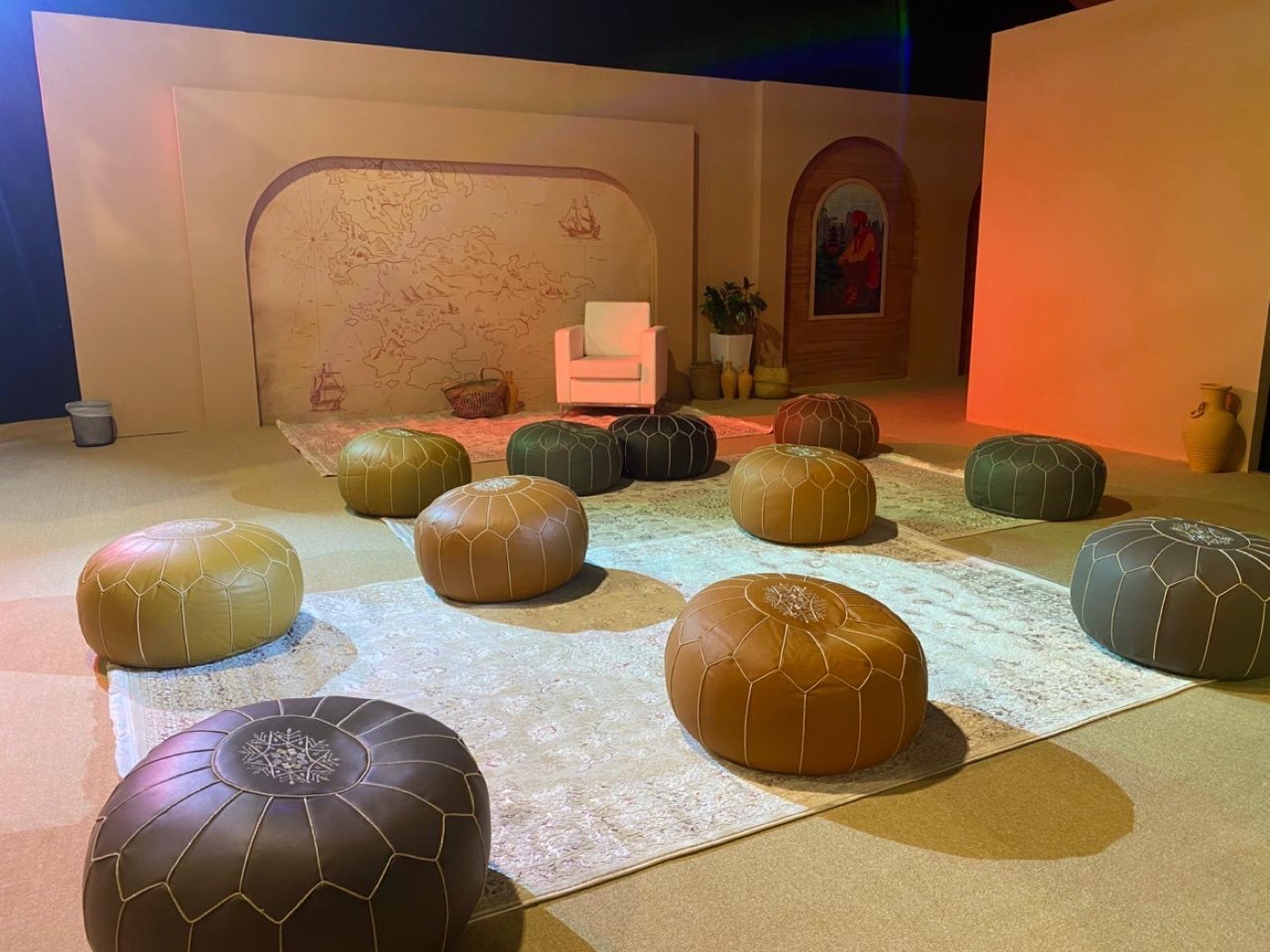 SINF 2025 storytelling zone with Moroccan leather poufs and Ibn Battuta travel map